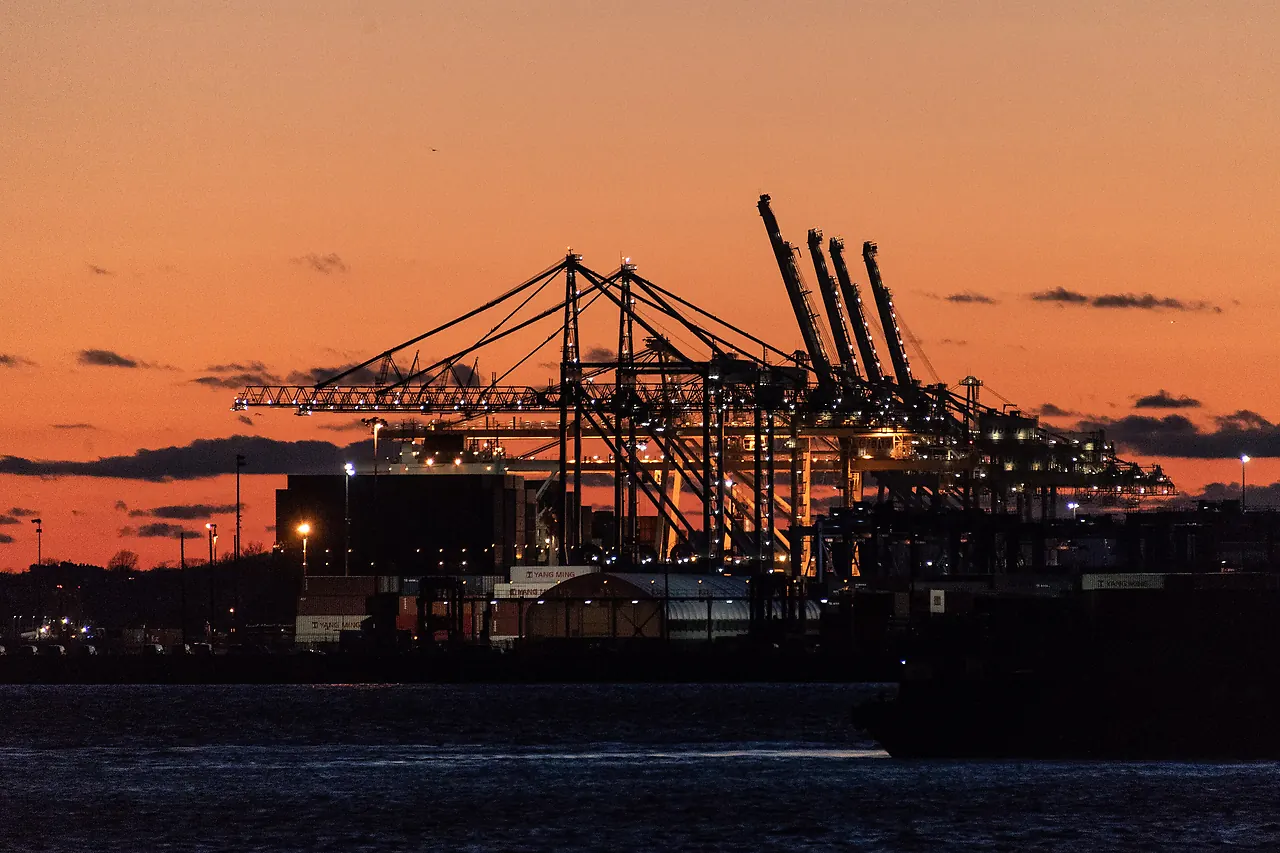 Container cranes at a port after dark